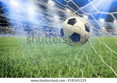 soccer ball in goal with spotlight Royalty-Free Stock Photo #418545529