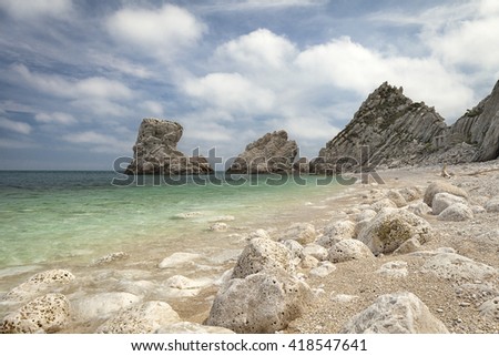  Two Sister (Due Sorelle)  bay , Conero Mountain in the adriatic sea, Italy. Blue sky background with clouds