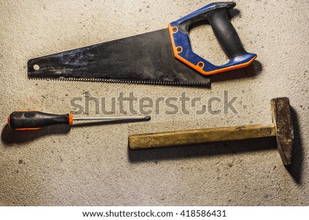 A few home related tools on a cement background