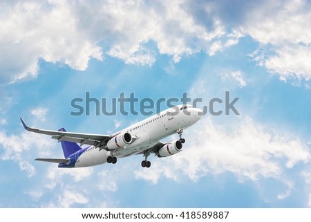 Airplane flying on blurred blue sky and pattern of white cloud in evening light Royalty-Free Stock Photo #418589887