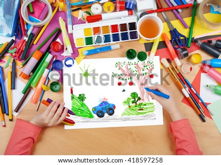 police car on outdoor, child drawing, top view hands with pencil painting picture on paper, artwork workplace