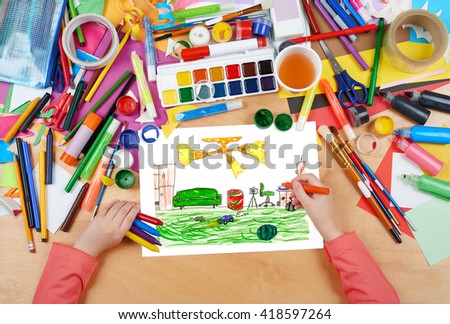 home interior, living room with toys, child drawing, top view hands with pencil painting picture on paper, artwork workplace