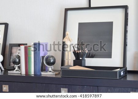decorative tray with book and pencils on wooden table at home