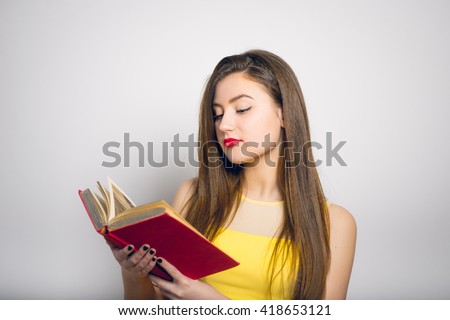 beautiful girl holding or reading a book in a yellow dress, closeup isolated on white background