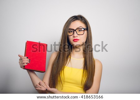 beautiful girl holding or reading a book in a yellow dress, closeup isolated on white background