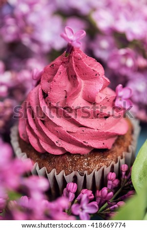 Food, food styling, cooking. Close up purple cupcake with purple lilac