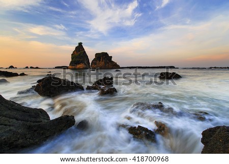 sunrise and beautiful rock in the sea,,,this is an icon of the beach Sawarna, this icon in the name Tanjung layar ,, this place is located in Banten, Indonesia