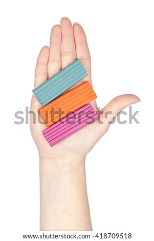 plasticine in a hand isolated on white background. school and office tools. stationery