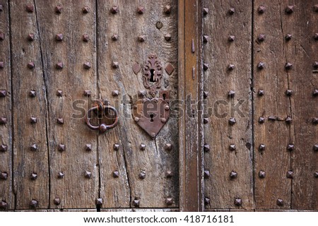Ancient weathered door with heart shape lock keyhole and handle. 