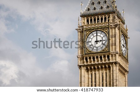 Big Ben, London, UK. A view of the popular London landmark, the clock tower known as Big Ben, showing 3pm as the time set against a blue and cloudy sky. Royalty-Free Stock Photo #418747933