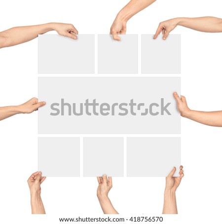 a hand holding a large blank sheet of paper isolated on white background