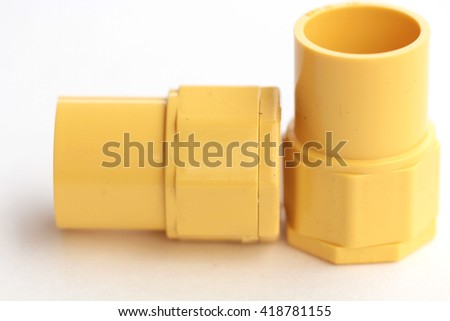 yellow pvc plumbing fittings on white background