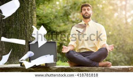 Young yoga position businessman relaxing in nature outdoor Royalty-Free Stock Photo #418781818