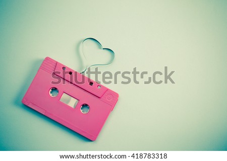 audio cassette with magnetic tape in shape of heart - vintage effect style picture. Minimal concept.