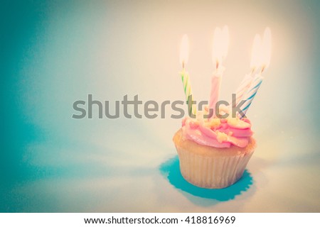 Pink Birthday cupcake with candle lighting retro effect image