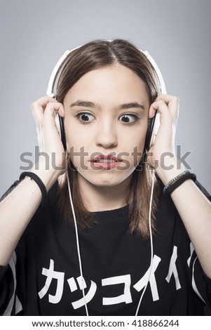 Girl's portrait listening to music with headphones