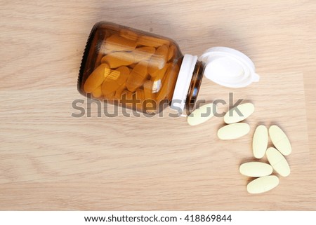 Closeup of a Glass Prescription brown bottle with pills