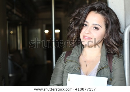 Young brunette woman traveling by train