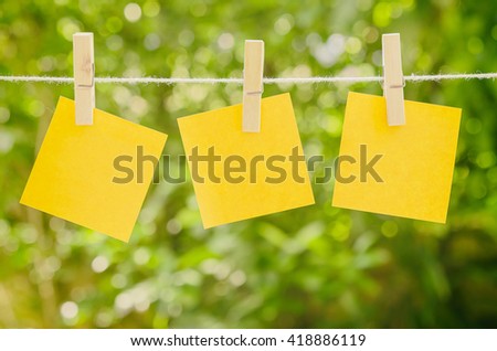 Paper note with peg on green background