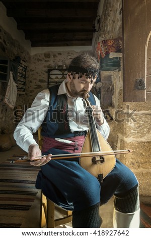 Cretan lyre player Royalty-Free Stock Photo #418927642