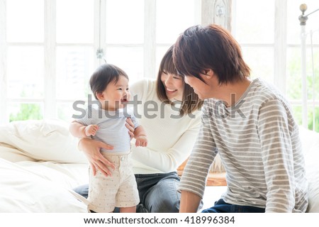 portrait of young asian family relaxing Royalty-Free Stock Photo #418996384