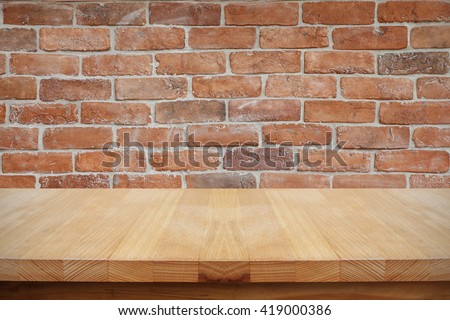 Empty table on brick wall background.