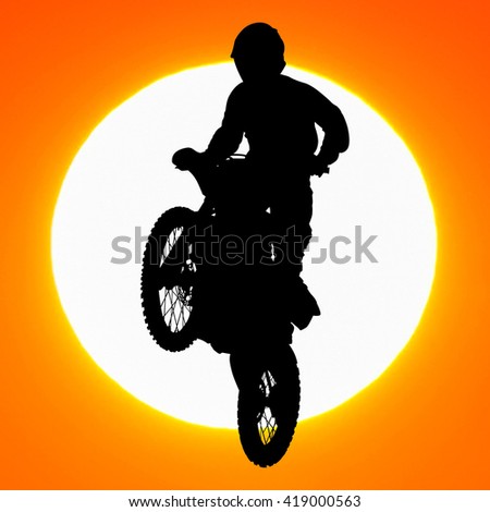 silhouette of motocross rider jump in the sky at sunset