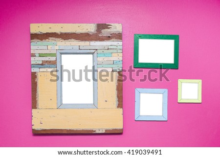 4 Empty vintage frame isolated on pink cement wall.