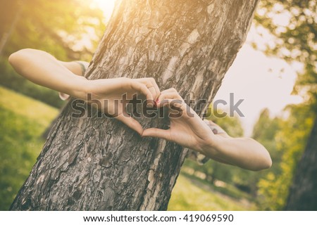 Girl sharing her heart with the tree.