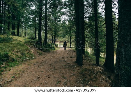 People hiker walking in the Misty mountain forest. Green pine forest landscape. Mountain trek