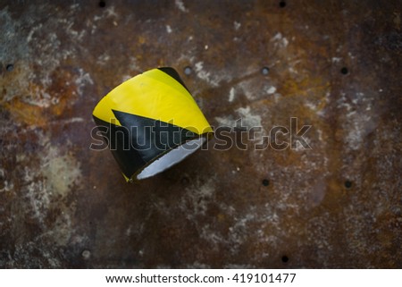 A shot of a black and yellow tape use to crate a barrier around work place.