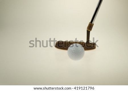 Practicing putter. Golf club and ball. 