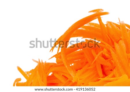 Close up of fresh shredded carrots on a white background.