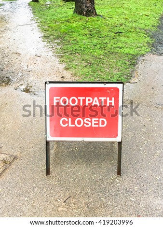 A red metal sign for a closed footpath