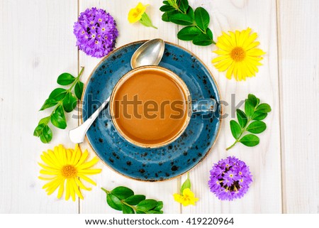 Coffee  in a blue retro cup with Flowers. Studio Photo