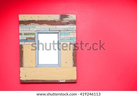 Empty vintage frame isolated on red cement wall.