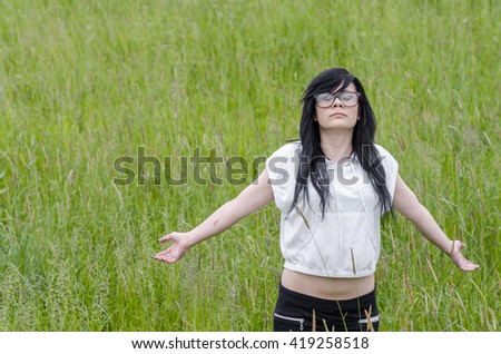 Emo girl stands and loves life with a sense of freedom
