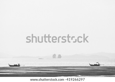 Long tail boat in early afternoon mountain lake. Black and white photography. Koh Yao, Phuket Thailand
