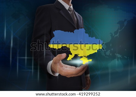 Businessman showing map of Ukraine on globe background