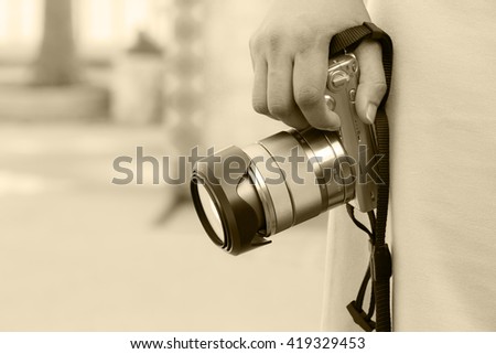 Hand of woman holding the digital camera