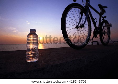 Drinking fresh water after exercise. Low lighting when twilight time. Low Key Picture.
