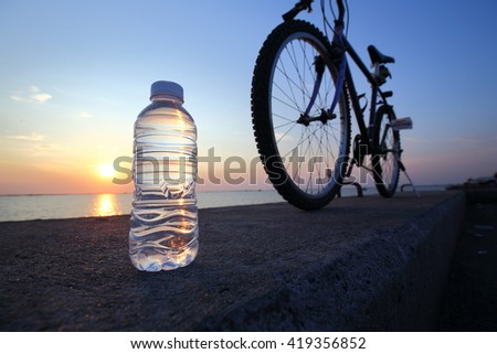 Drinking fresh water after exercise. Low lighting when twilight time. Low Key Picture.
