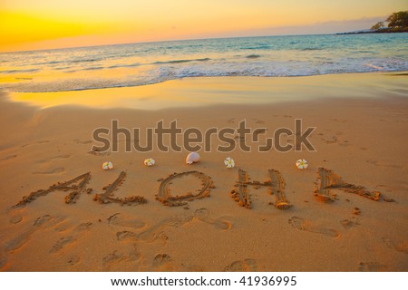 aloha written in the sand on the hawaiian beach