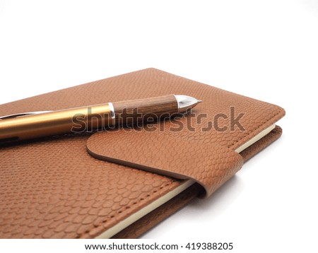 Wood pen with leatherette book  on white background 