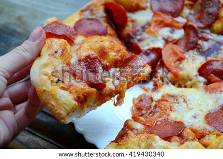 Big hot pizza with tomatoes and pepperoni