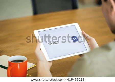 Man searching GLOBAL with tablet pc