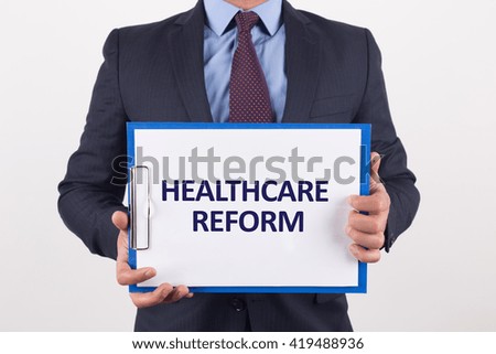 Man showing paper with HEALTHCARE REFORM text