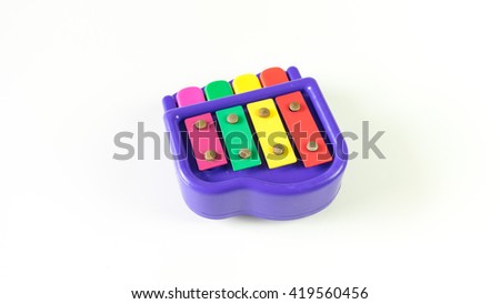 Cute colorful mini piano. Isolated on white background. Slightly de-focused and close-up shot. Copy space.