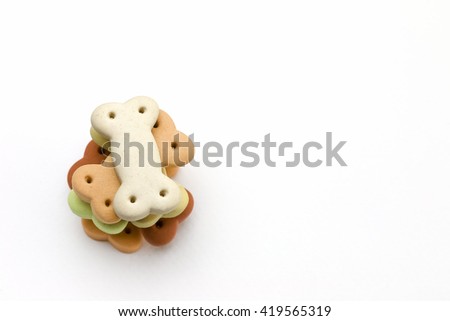 Dog food , Pile of dog biscuits in the shape of a bone for pet food, in square frame shape for background use. Royalty-Free Stock Photo #419565319