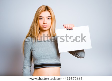 Pretty blond girl holding a blank sheet of paper to add your text